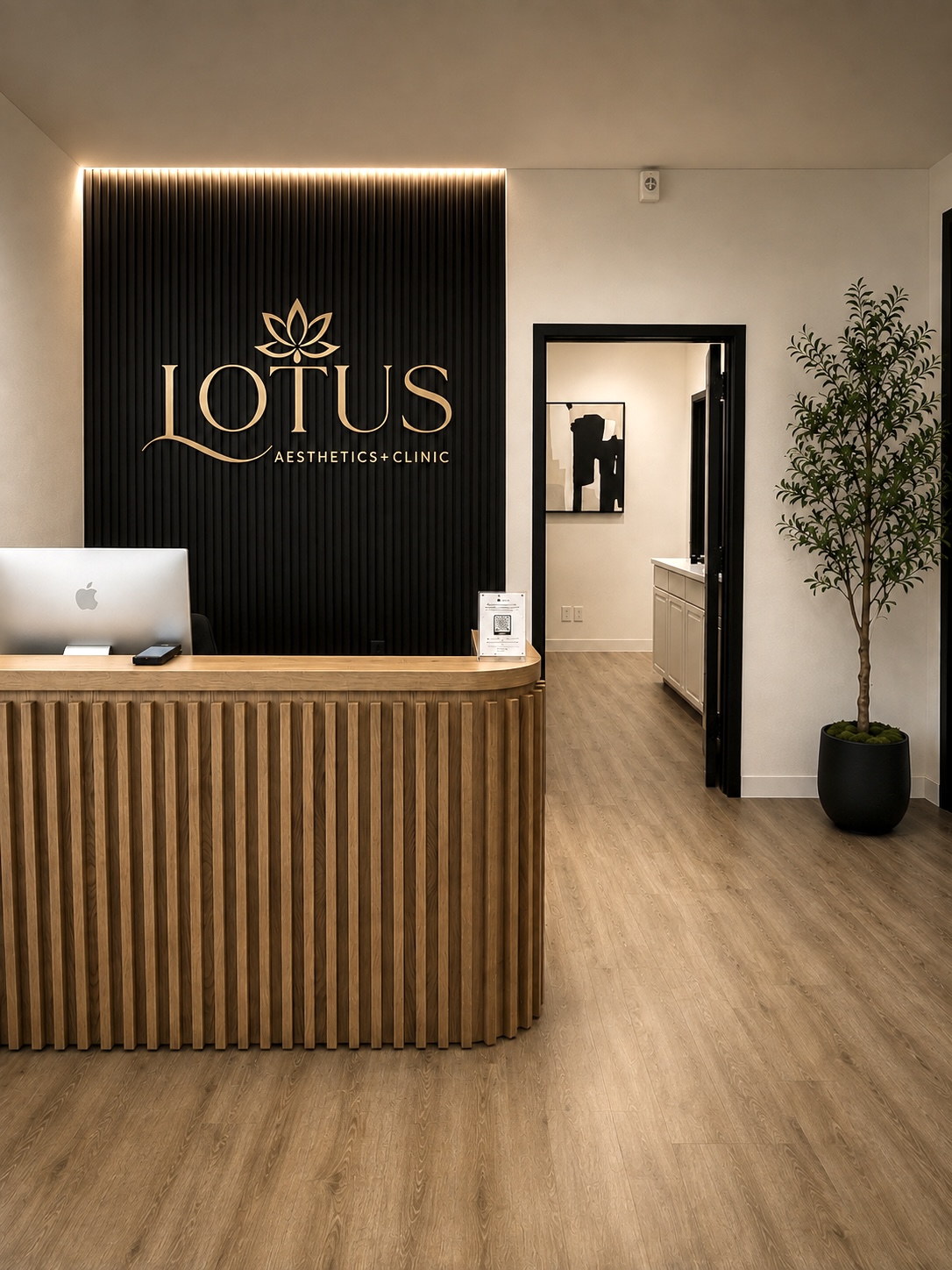 Lotus Aesthetics Clinic reception area with illuminated logo, wood reception desk and modern interiors